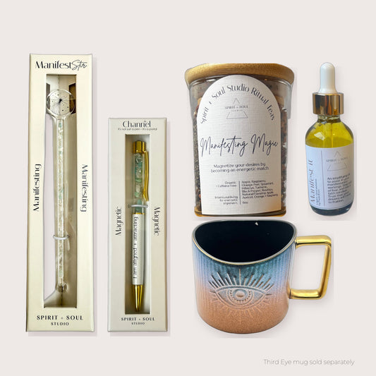 Morning Ritual Luxe Manifesting set with the Manifesting Manifest Stir, Manifesting Magic Ritual Tea, Magnetic pen and Manifest It Oil, shown with the Third Eye mug (sold separately)